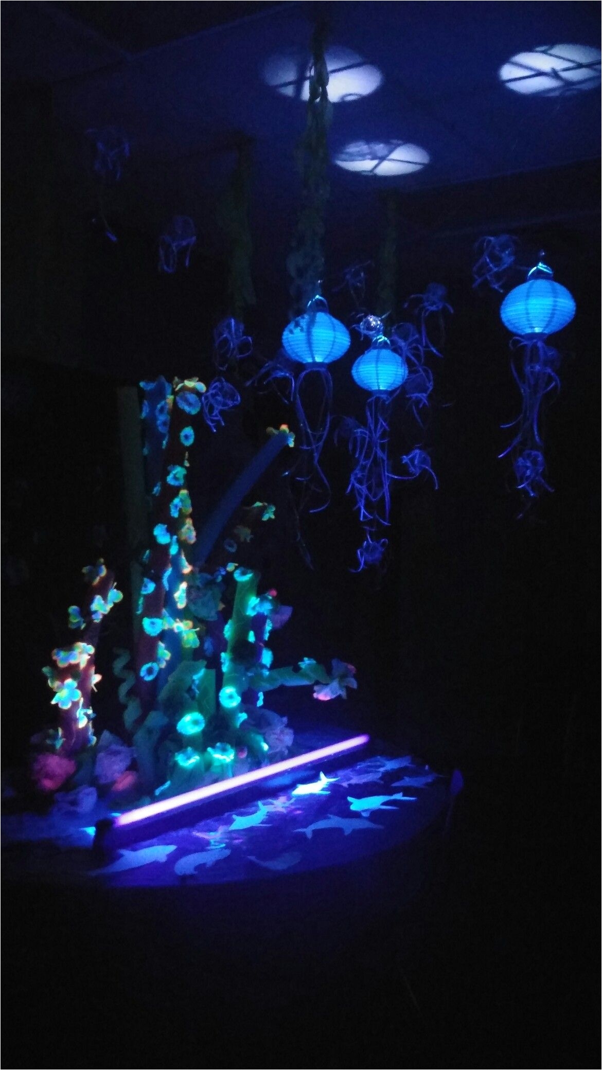 pool noodle and neon flower for coral reef glows with black light under the