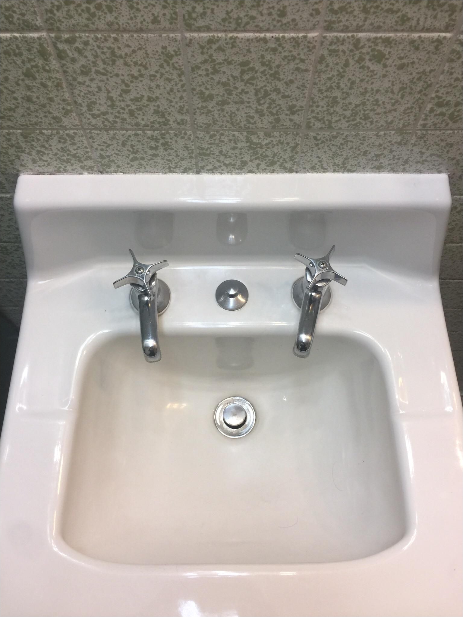 this bathroom sink has separate faucets for hot and cold water