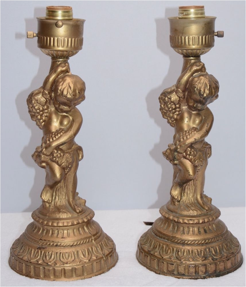 pair of vintage cast metal electric table lamps with cherubs for restoring