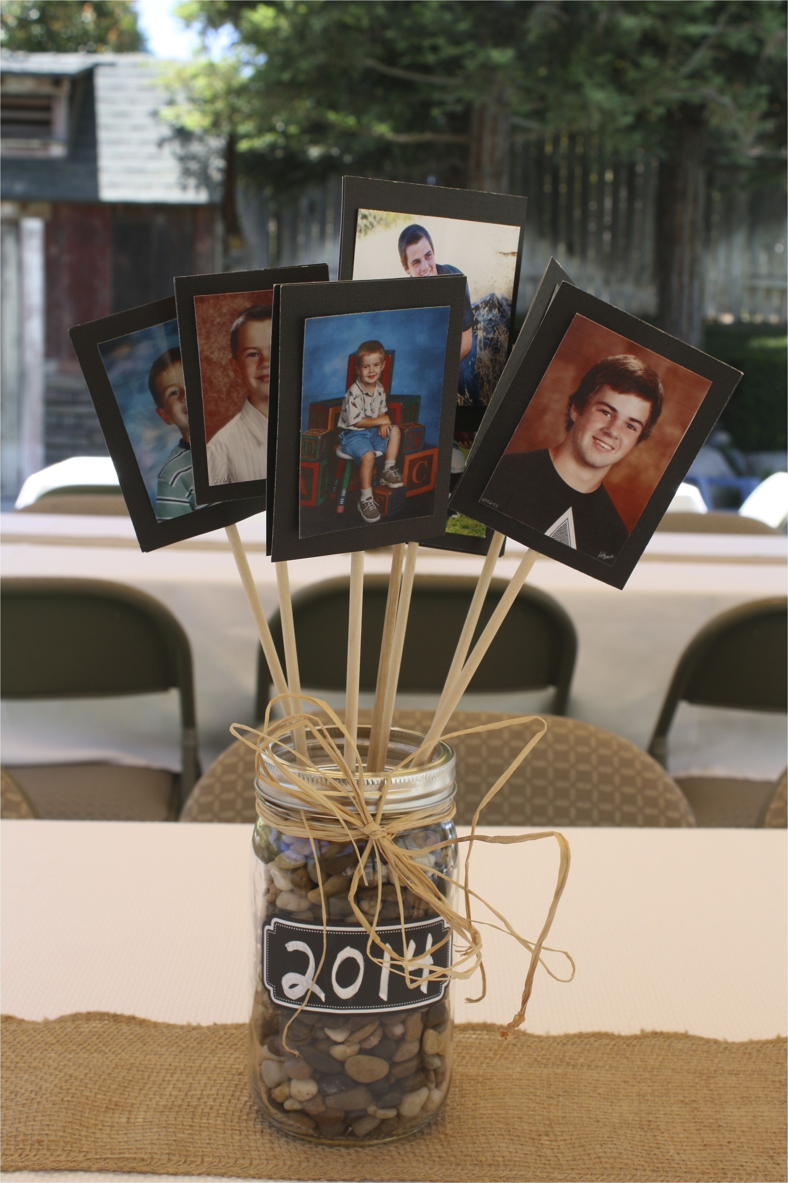 centerpiece for tables at a graduation party good for guysno flowers each picture is a school picture showcasing the grad in different grades