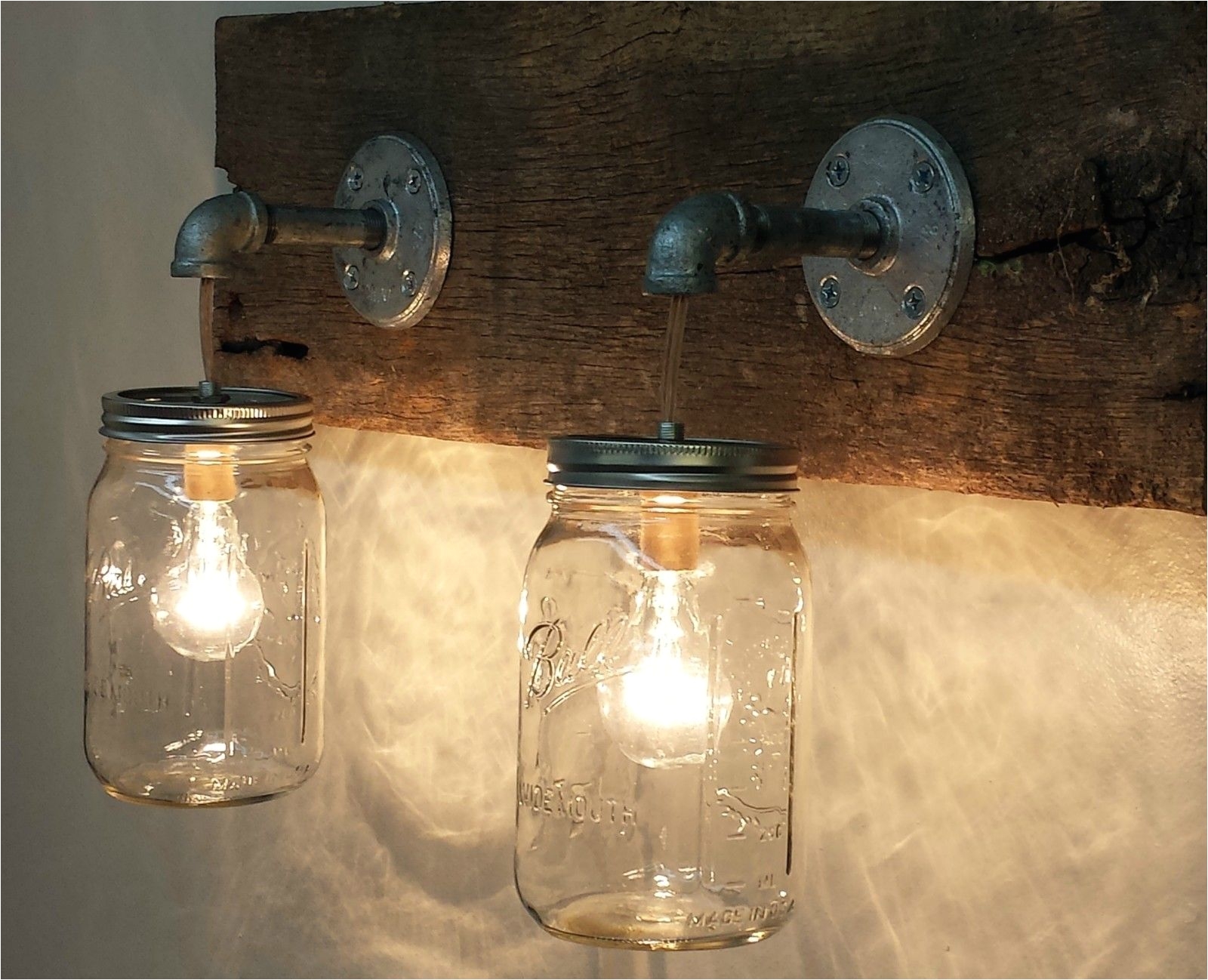 ball mason jar lights these will go on either side of the green gas station light we are going to make these and mount on a piece of barn wood