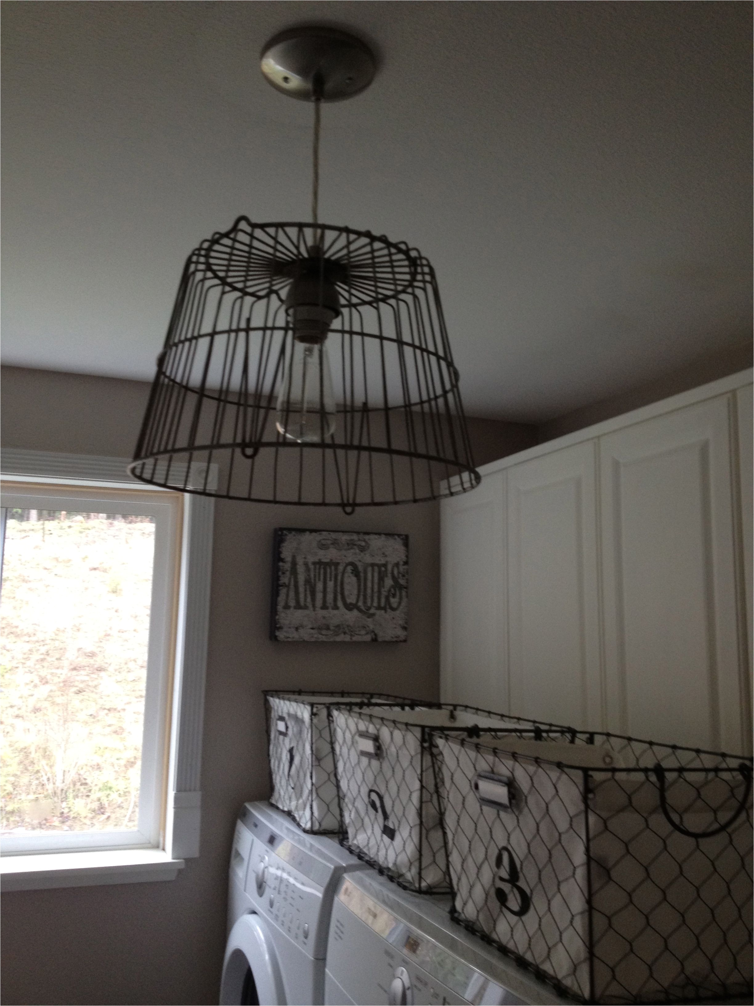 love the wire basket light fixture in this laundry room cage pendant light cage