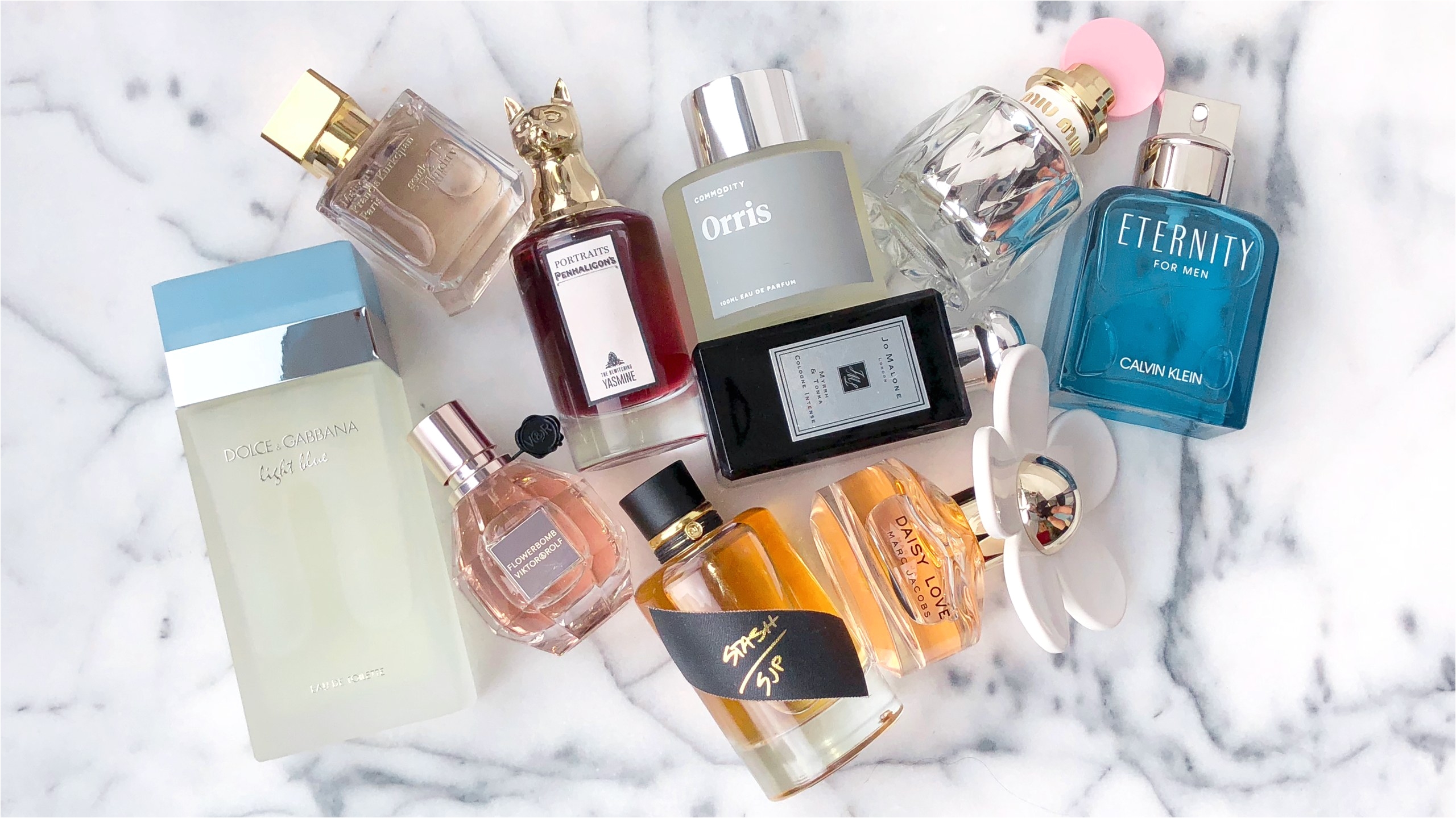 bottles of perfume against white marble background