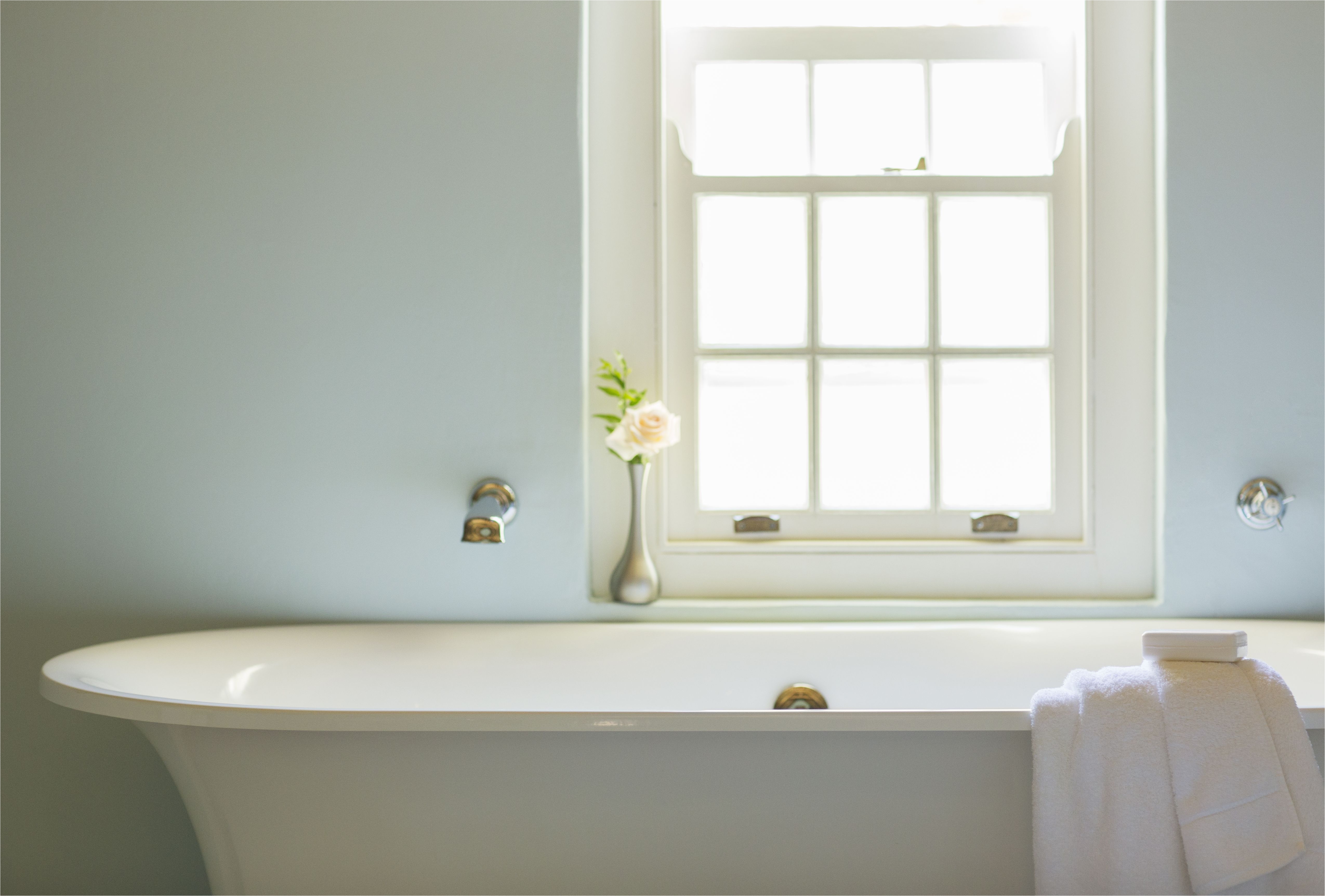 soaking tub below window in luxury bathroom 494358425 5aa1e931c064710037061882