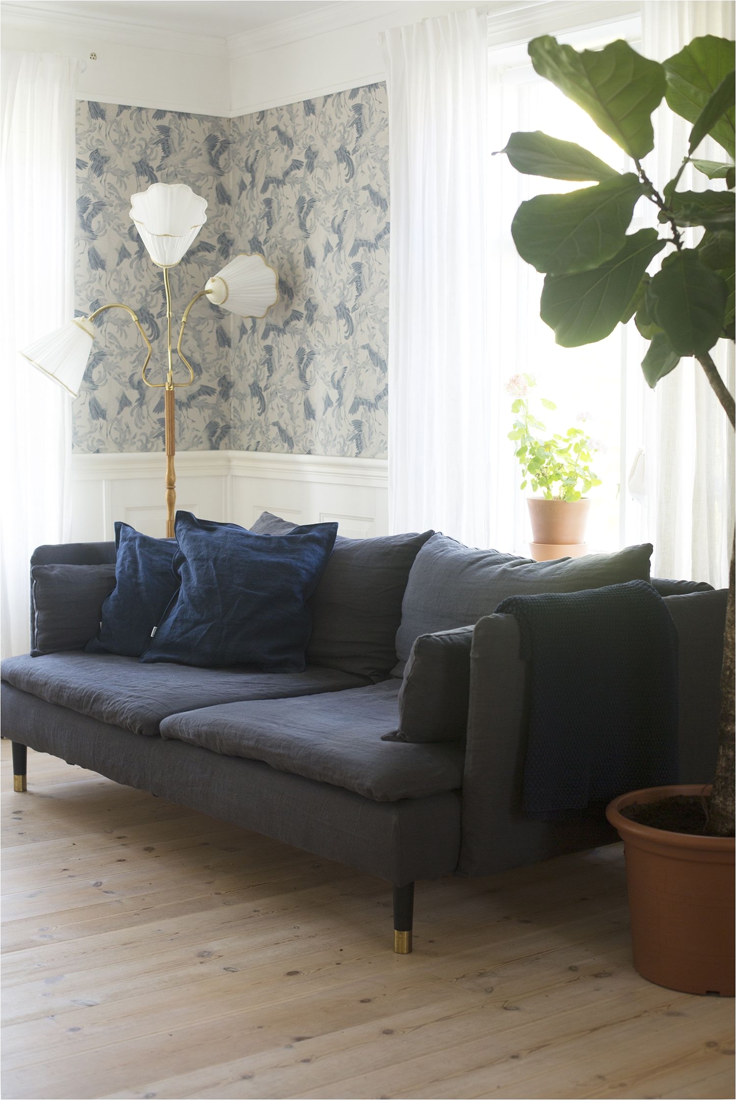 romantic vintage inspired living room with blue patterned wallpaper huge fiddle leaf tree and retro lamp dark grey linen sofa ikea sa¶derhamn sofa with
