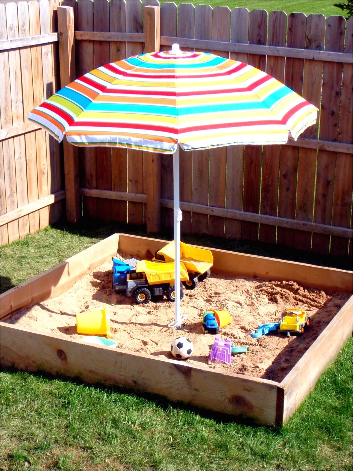 use beach umbrella to provide shade over the sandbox to secure use pvc that has been drilled into the base of the sandbox and stick in the umbrella pole