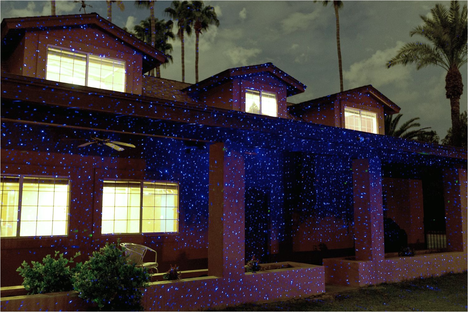 the blue illuminator light creates a frost look on trees and homes indigo twilight laser christmas lightsholiday