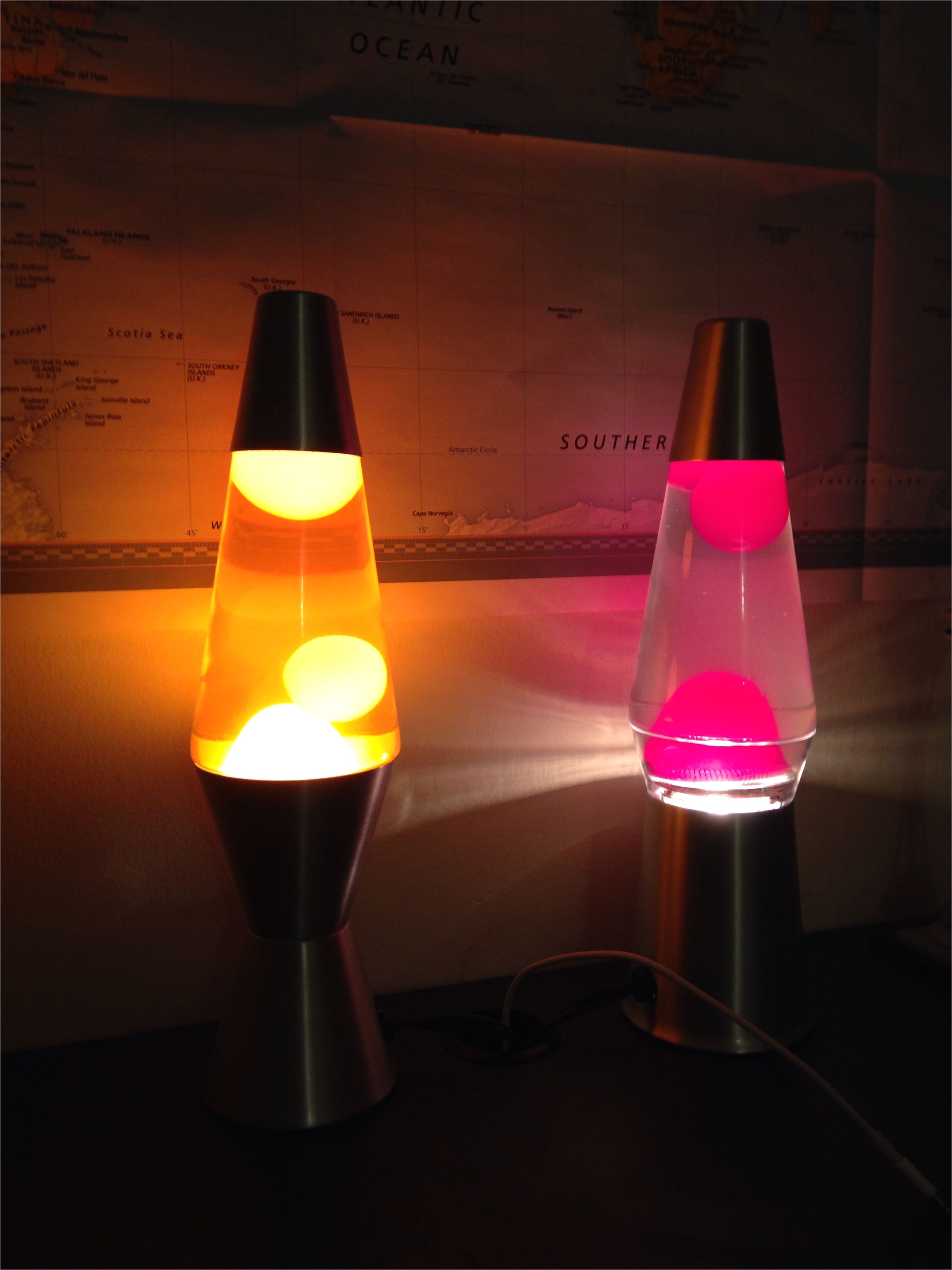 two eleven inch lava lamps one with orange liquid and white wax and one target exclusive clear view with clear liquid and pink wax