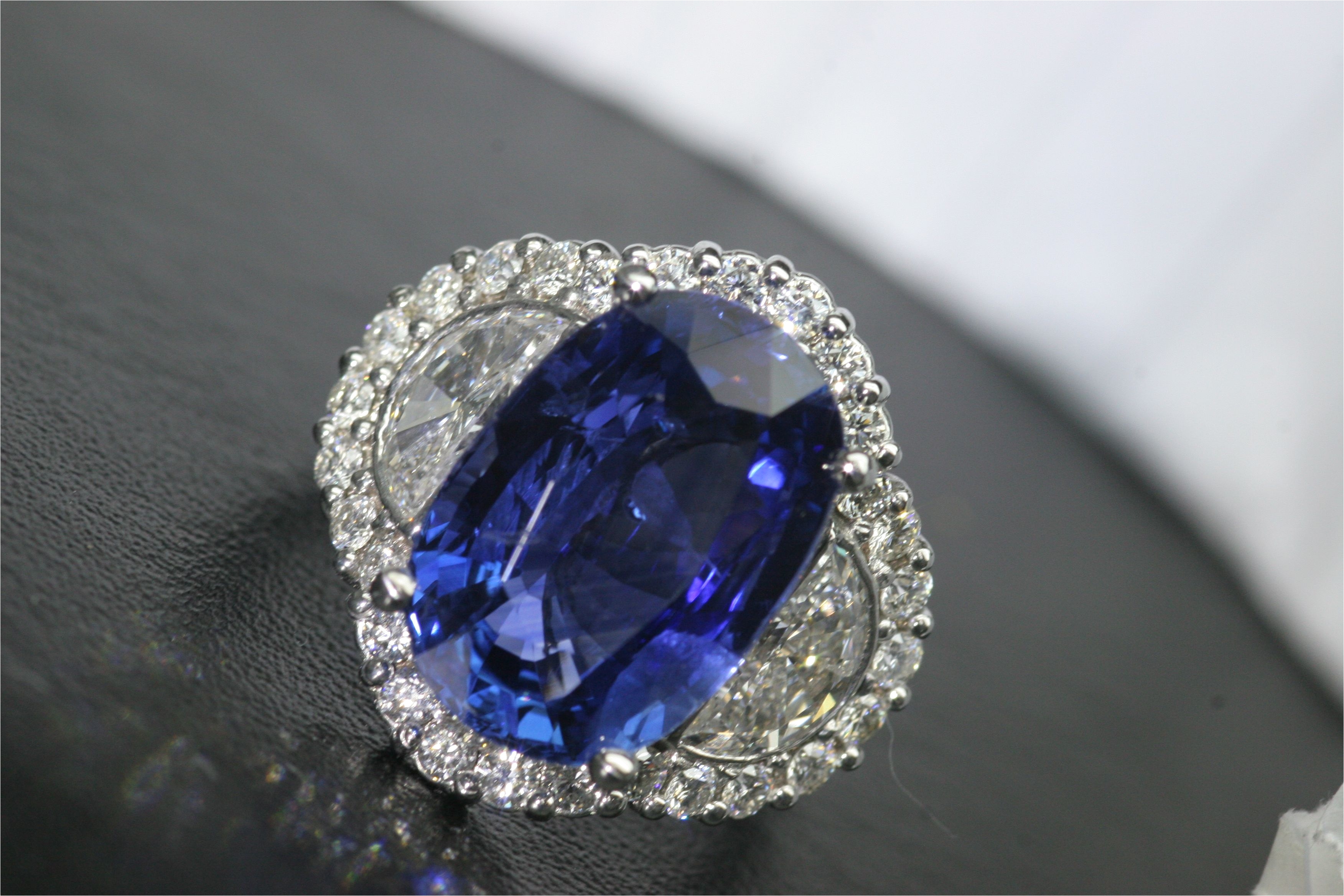 graceful engagement rings light blue diamonds on a 4 25 carat oval sapphire with halo od surrounding diamonds