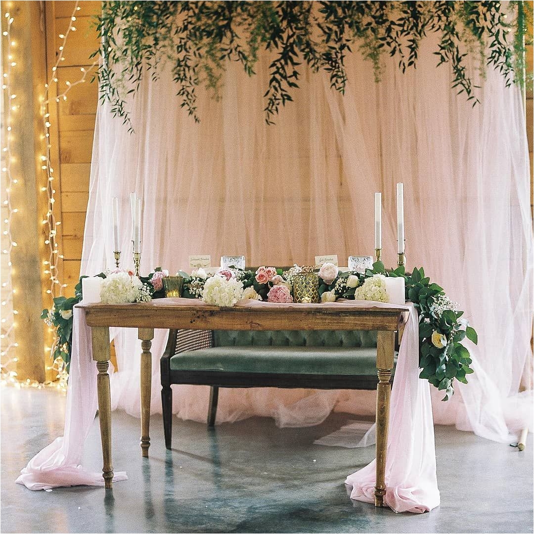 romantic light pink and green wedding reception inspiration with silk fabrics and table runners
