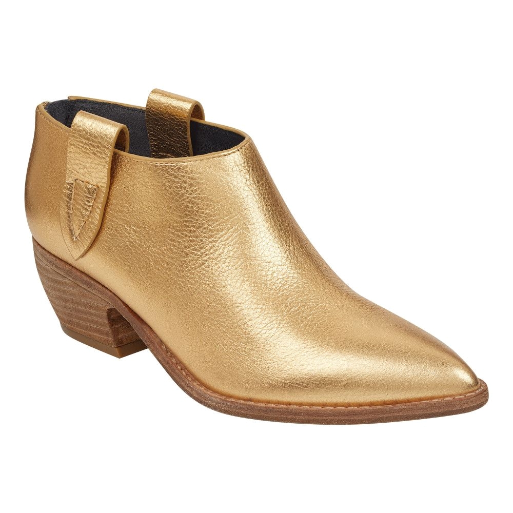 a minimalist profile and a low curved heel give the dorie bootie an of the