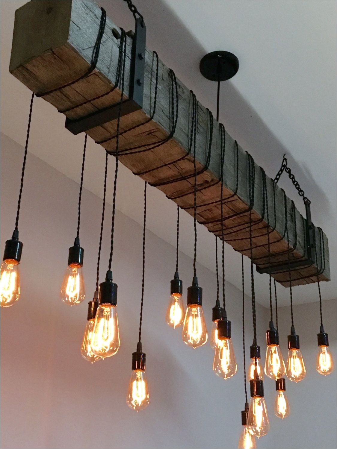 reclaimed hand hewn barn beam light fixture with wrapped lights and black metal hanging brackets we will customize the length of wire and black chain to