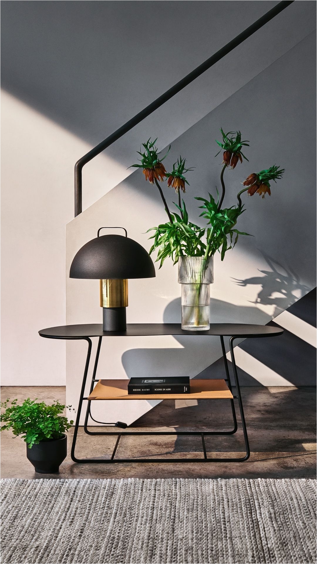 hm home this modern sofa table with a metal table lamp a large glass vase and a stoneware plant pot equals interior perfection