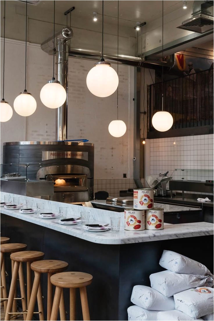 italian pizza restaurant in london with white marble high bench to watch