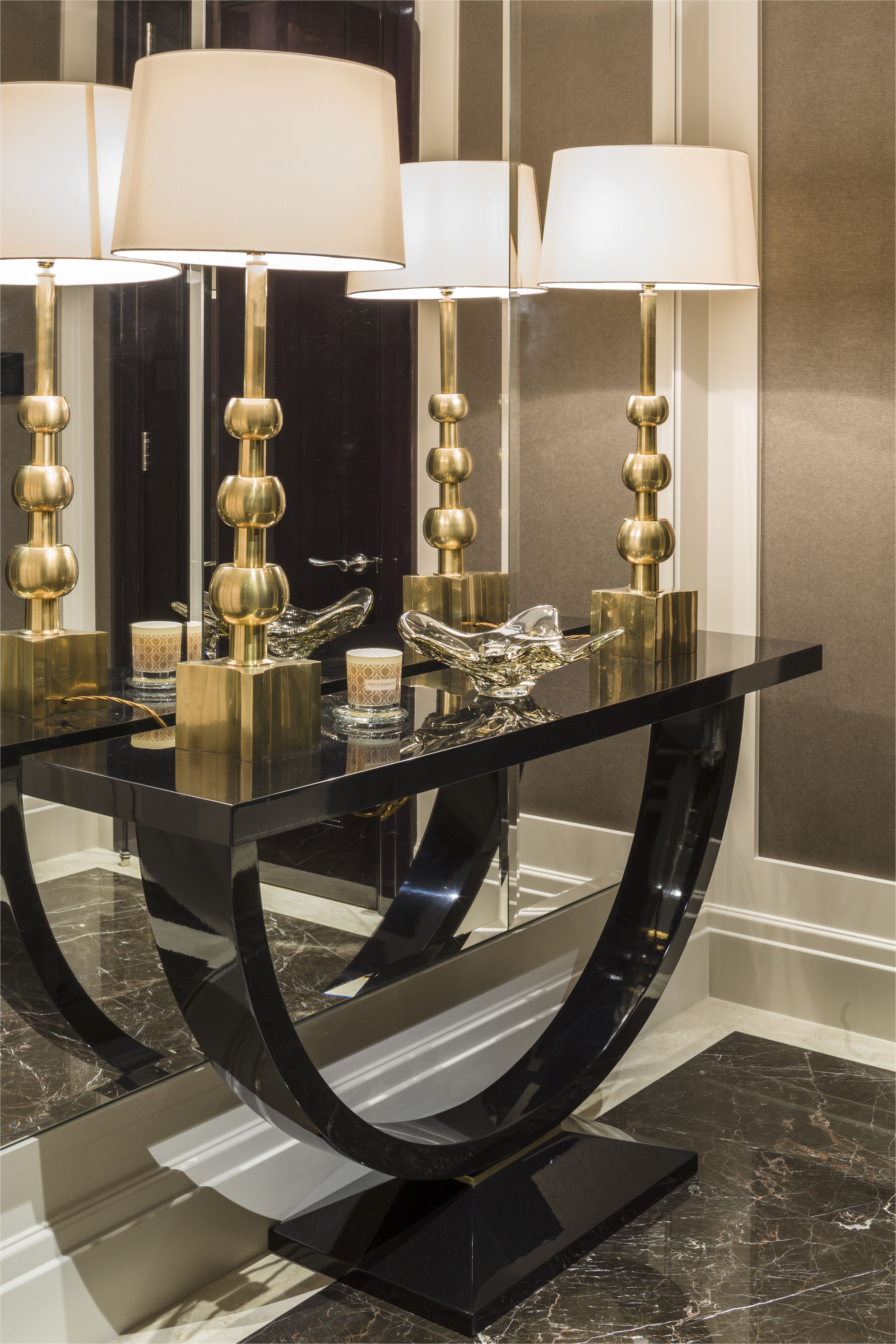 private apartment belgravia the entrance lobby features a console table and two brass based hardwick lamps with white shades from vaughan