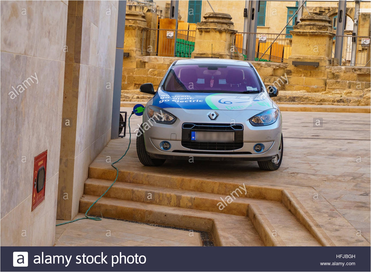 renault fluence z e charging behind the new energy efficient parliament building of malta in valetta