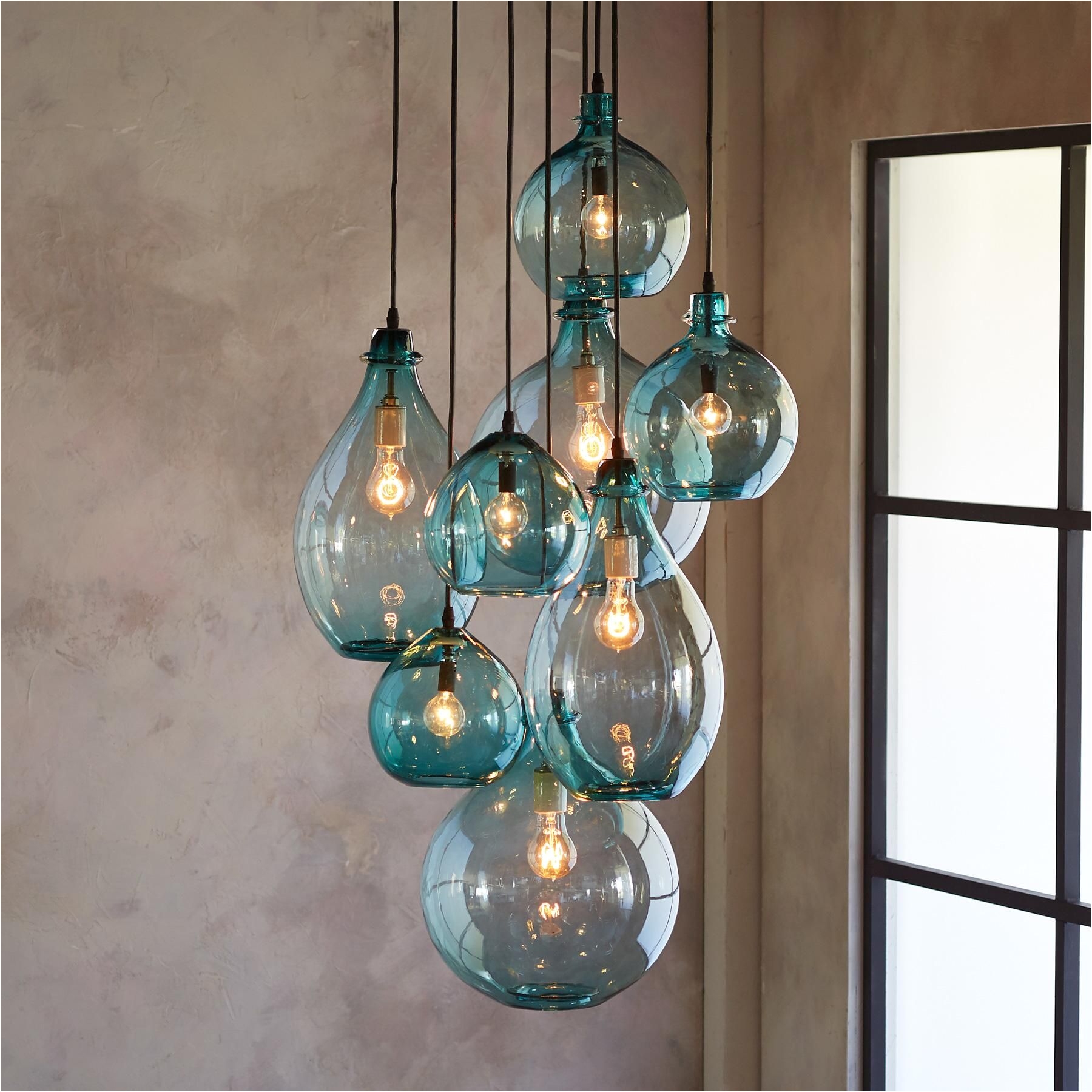 salon glass pendant canopy limpid turquoise drops of hand blown glass envisioned by a los angeles artisan cisco pinedo cluster together beneath a hand