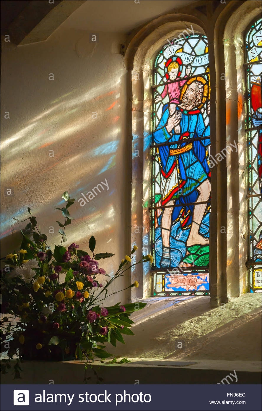 stained glass panel and transmitted light reflections from st nicholas church west itchenor west sussex uk