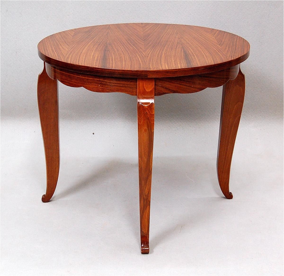 Art Deco coffee table in Santos rosewood and walnut The plateau the belt and legs are bordered by a brass studding Circa 1940