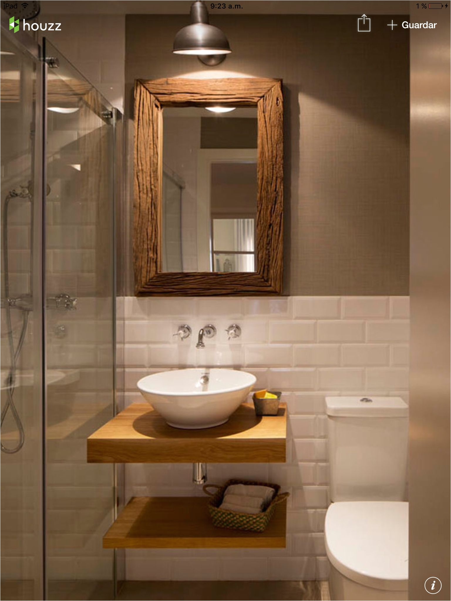 Half white tiles with contrast brown wall and white and brown bathroom fixtures and accents