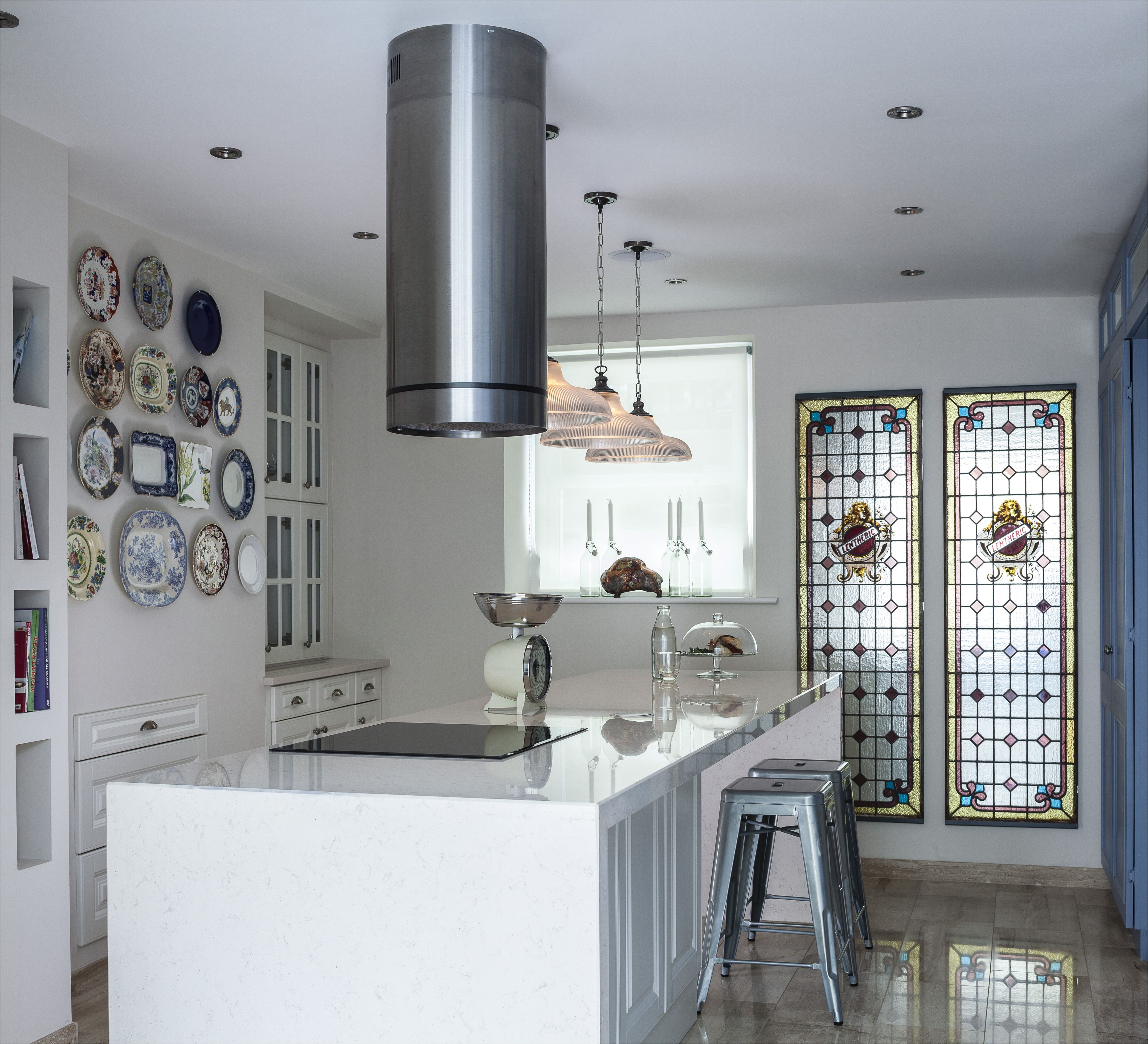 Basement kitchen design in Georgian house Long silestone island with bespoke joinery antique glass panels and antique plate wall Interior design