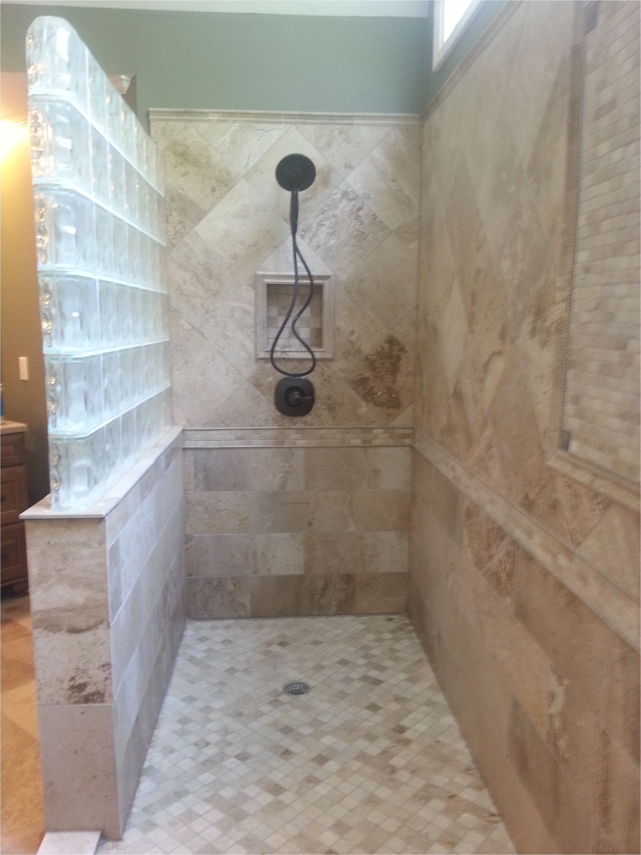 Luxurious bathroom remodel 12 ft custom tiled shower with glass block wall Travertine tile with custom niches on each side
