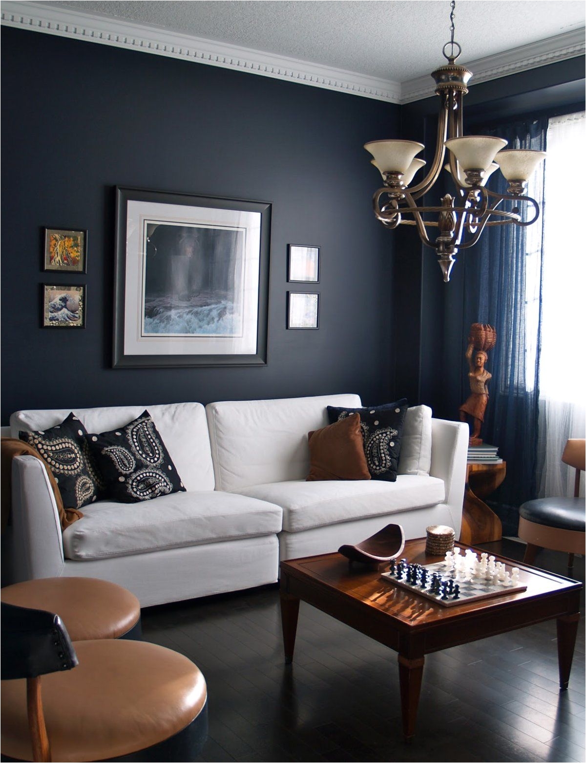 living rooms with dark navy blue walls with white sofa and classic chandelier Living Room Designs