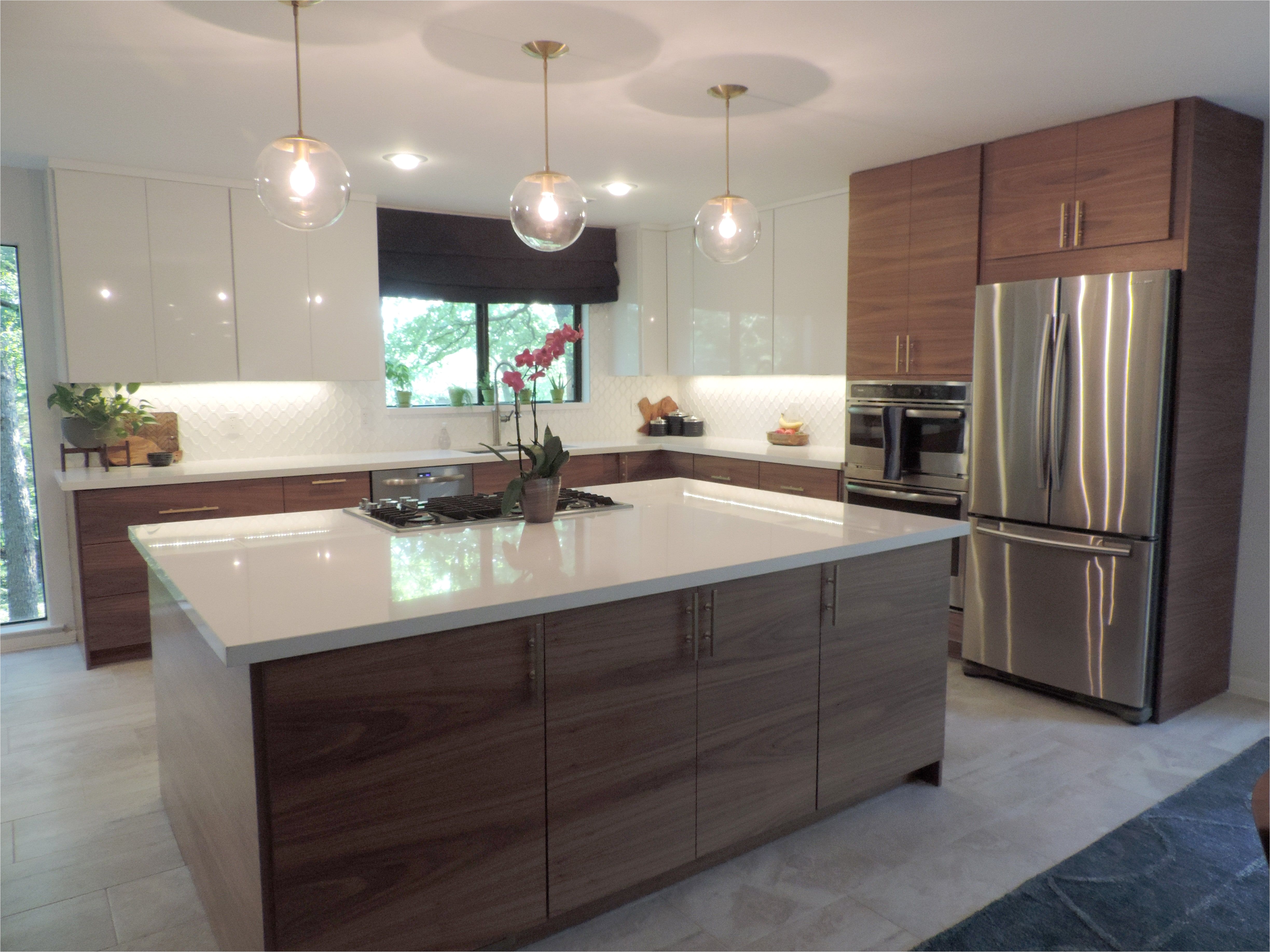 A Mid Century Modern IKEA kitchen for a gorgeous light filled Texas home Semihandmade Flatsawn Walnut doors Kraftmaid wall cabinets