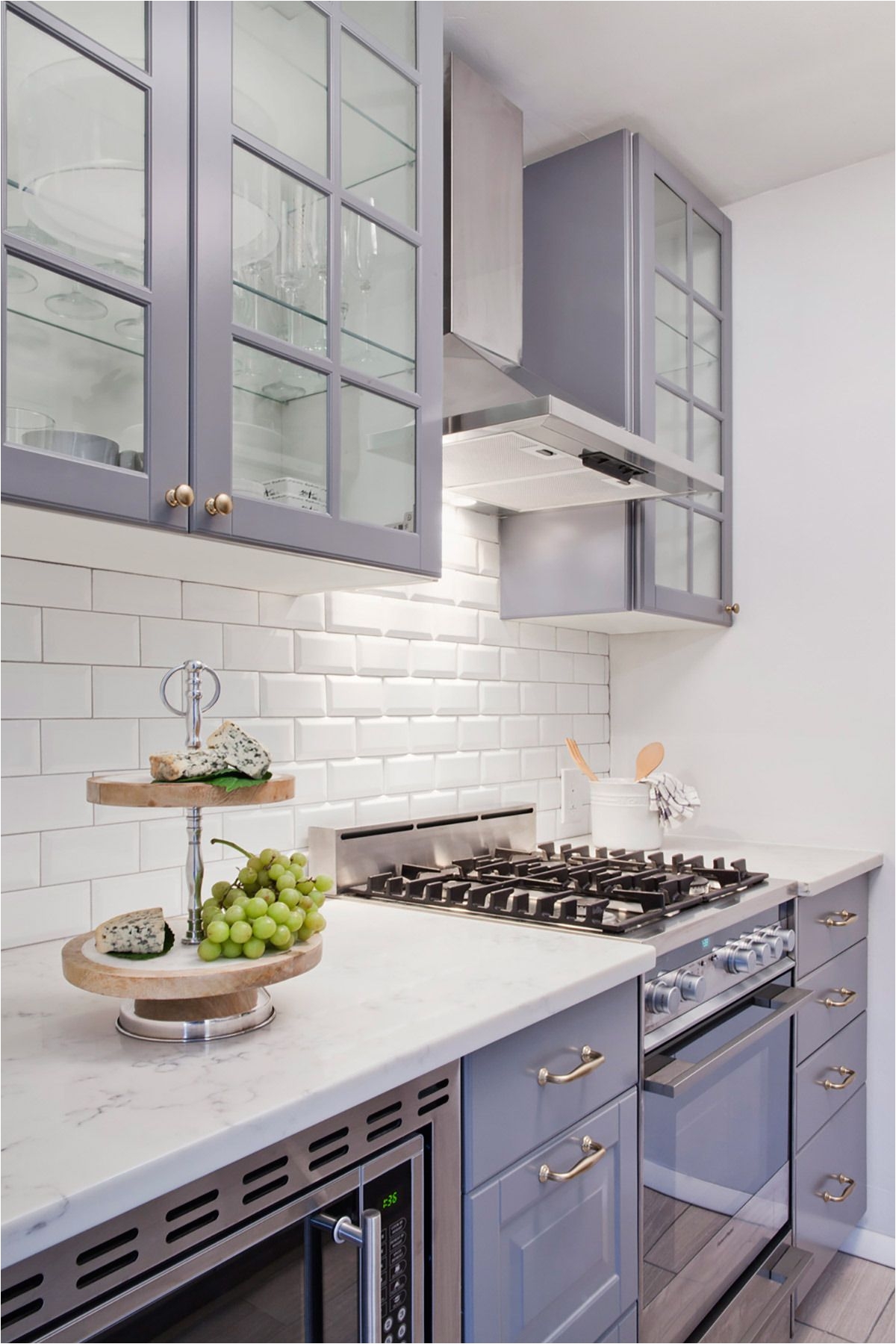 Grey IKEA cabinetry paired with white subway makes for a perfect small kitchen space Love the high cupboards