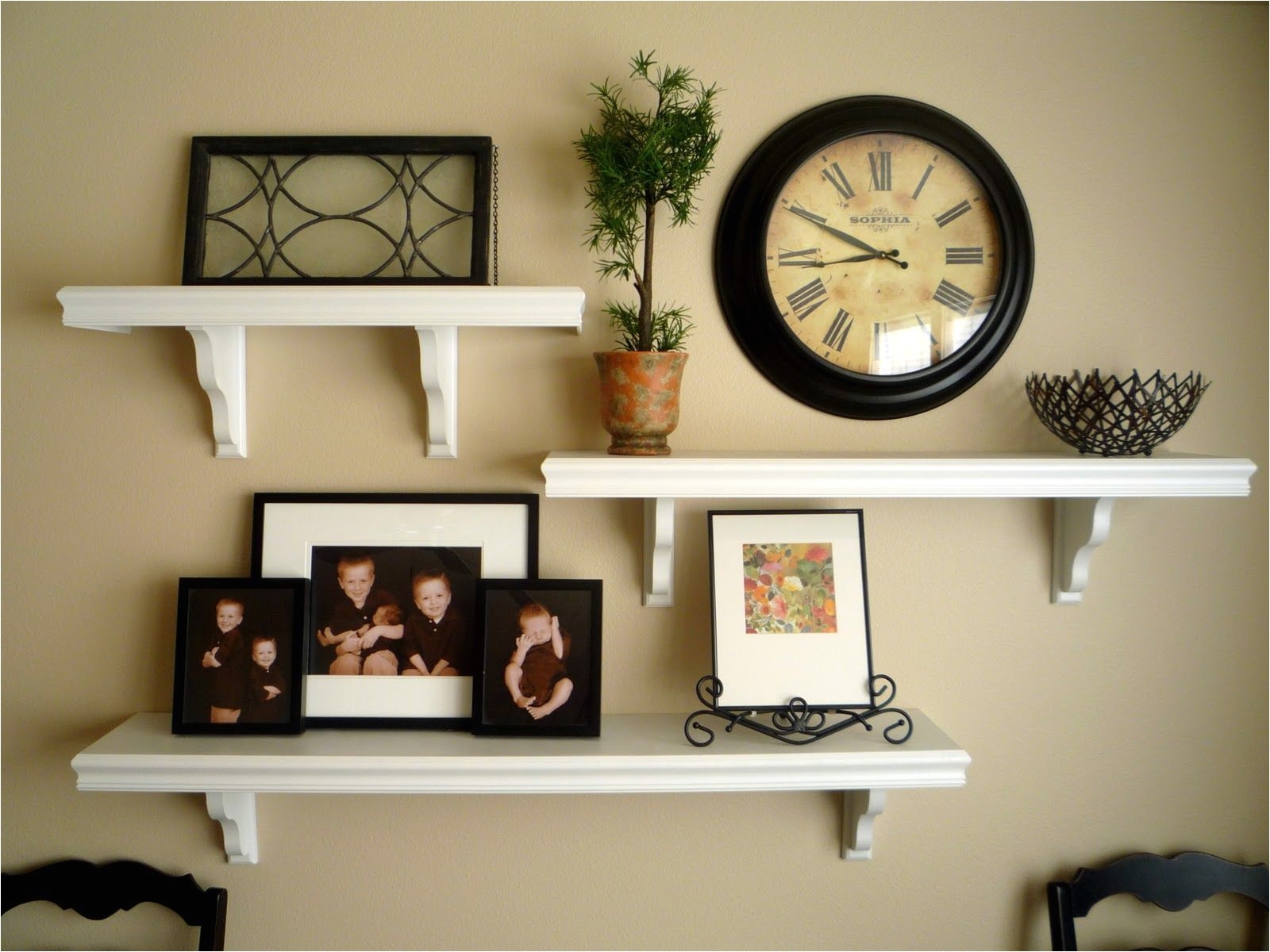 picture and shelves on wall to her