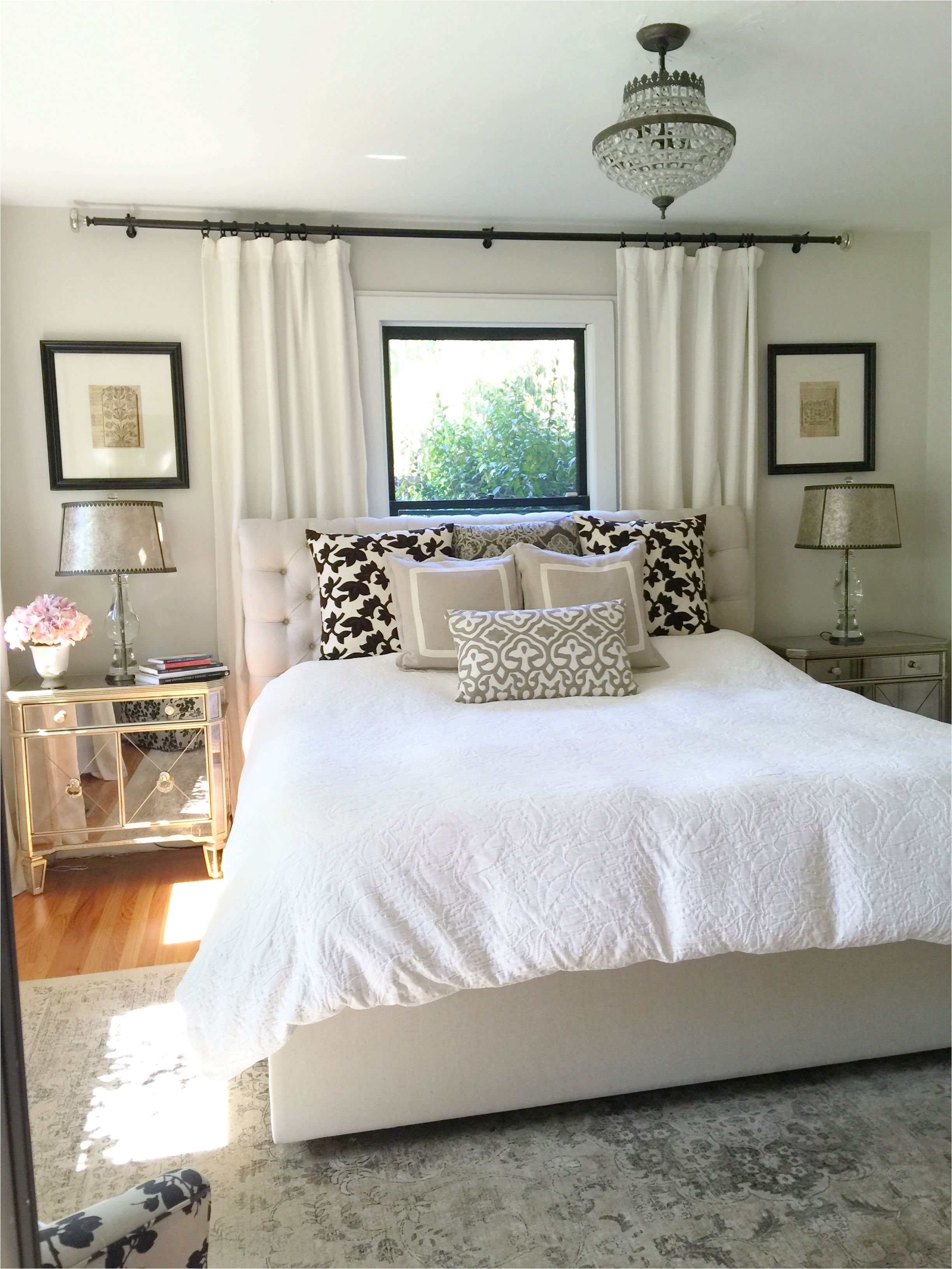 Neutral bedroom Window behind bed Bedroom window treatments Paint is Benjamin Moore winds breath