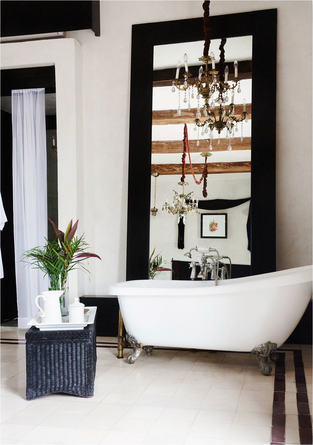 Beautiful bathroom with white tub and exposed wood ceilings