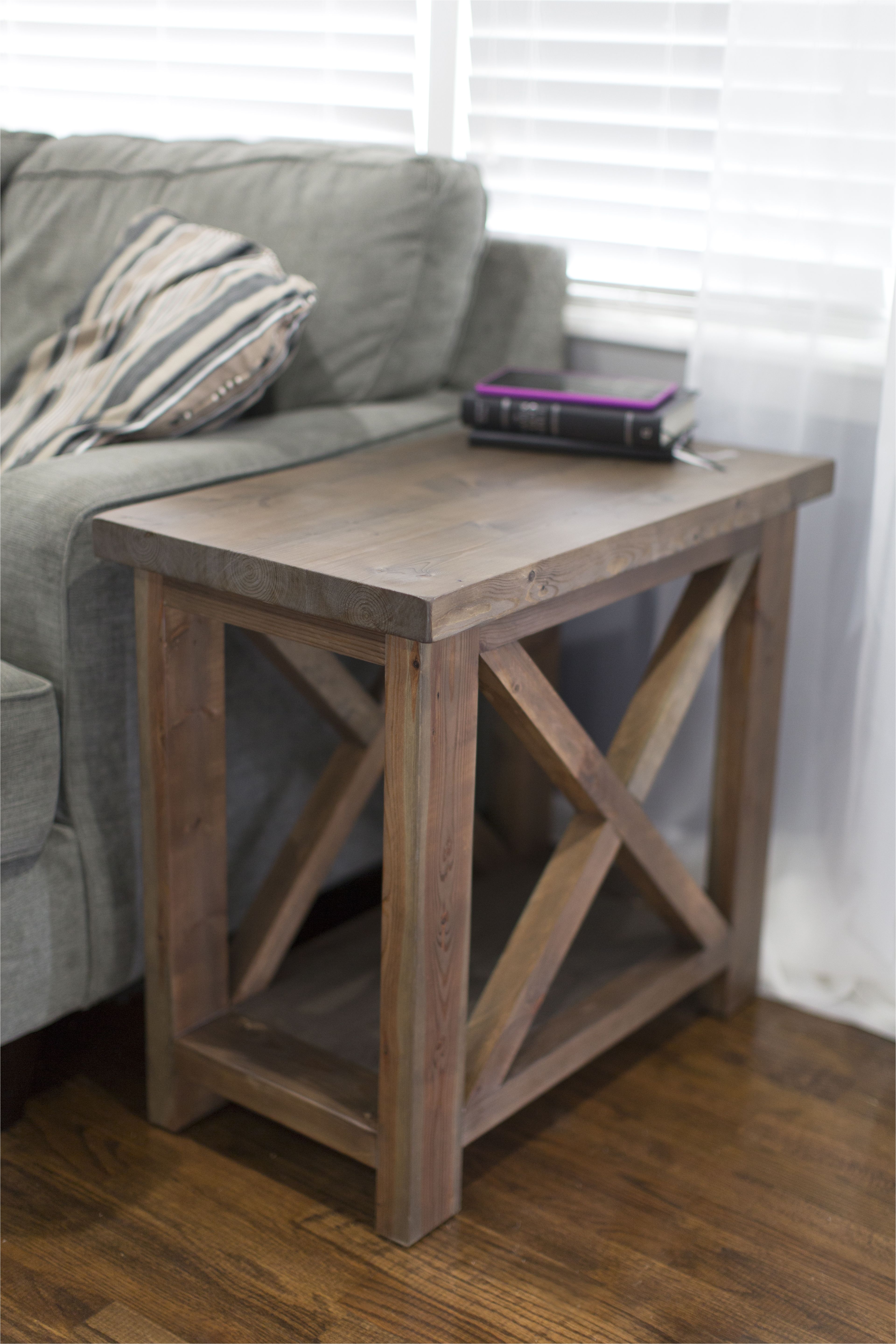 Rustic X style side table with a thick top and a bottom shelf for extra storage