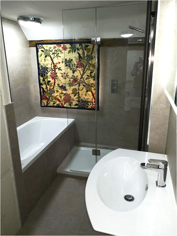 walk in shower next to alcove bath tub with japanese decor