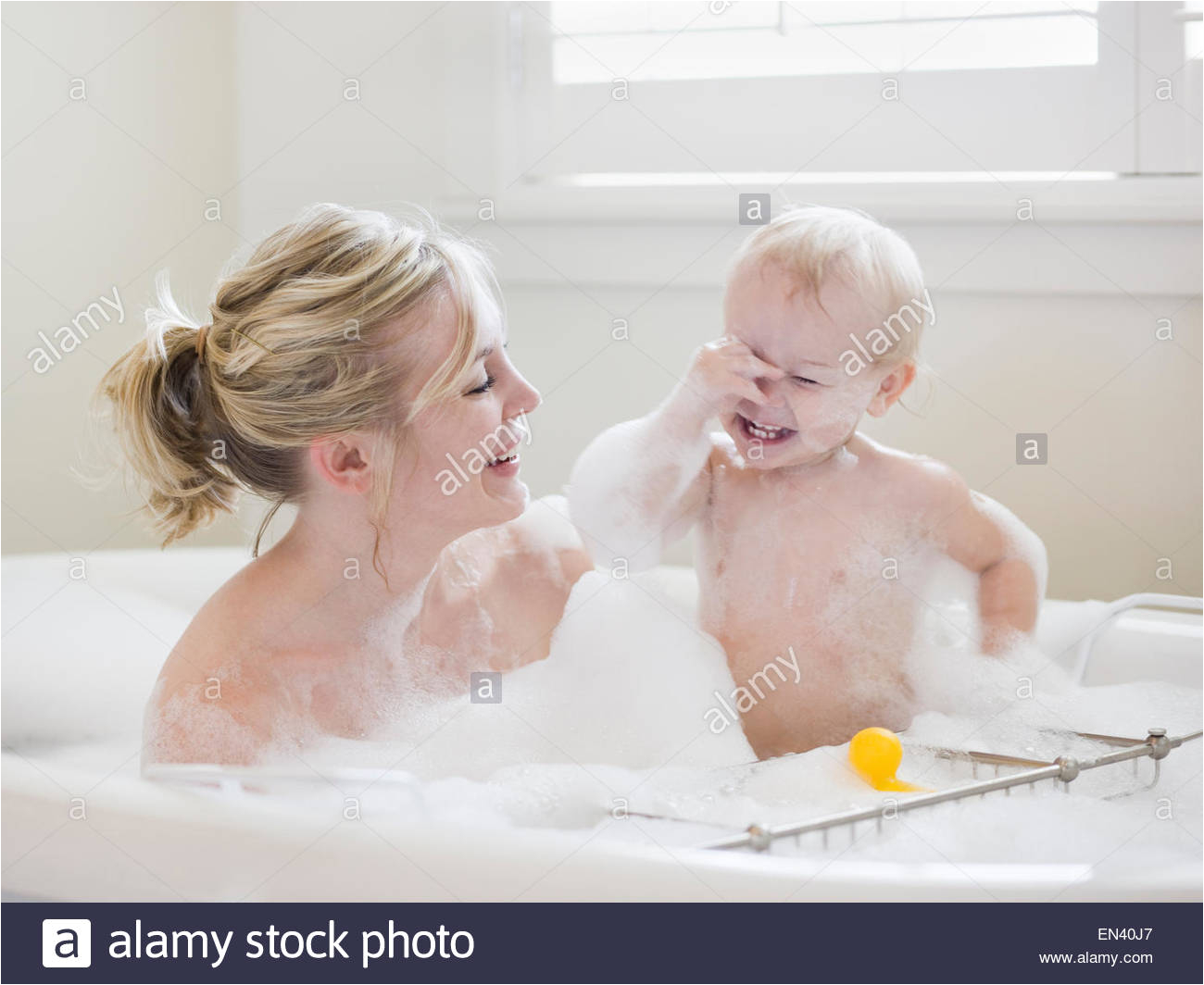 stock photo mother and baby taking a bubble bath