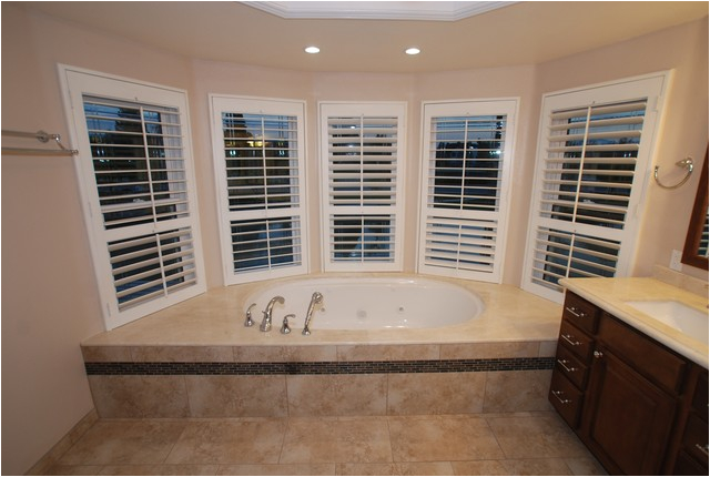 6 Foot Tub in Window Alcove and Glass Tile Inlaid Floors and Shower Bench Seat bathroom orange county