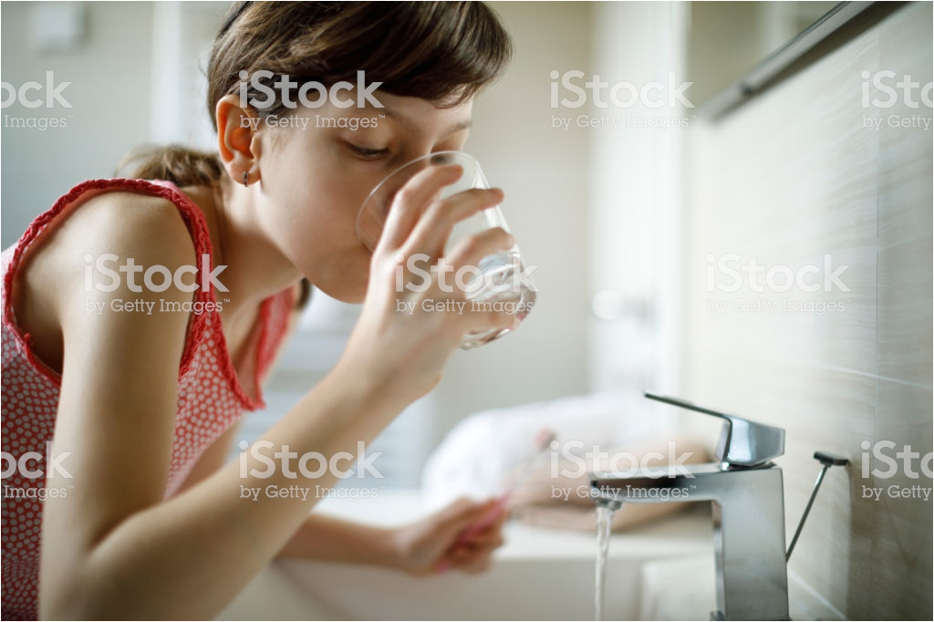 Bathtub Liner for Drinking Water Teenage Girl Drinking Water while Holding toothbrush In