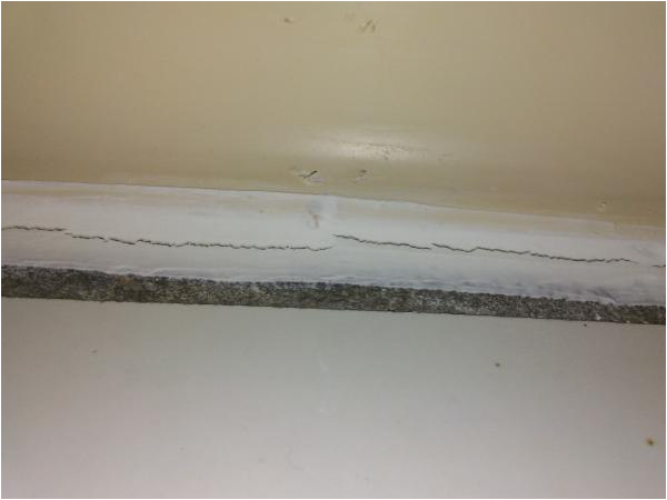 caulking cracking around tub tile liner help please