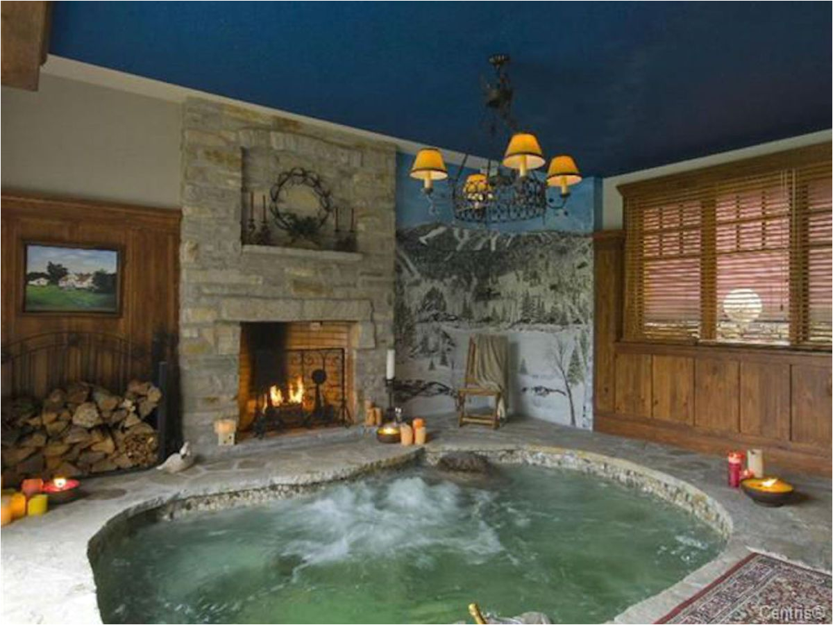 a quebec chalet with a fireplace next to the hot tub