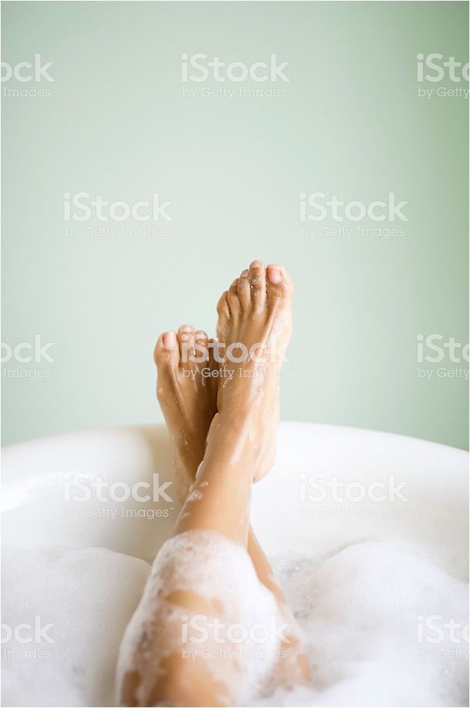 womans legs and feet in bathtub with bubbles gm