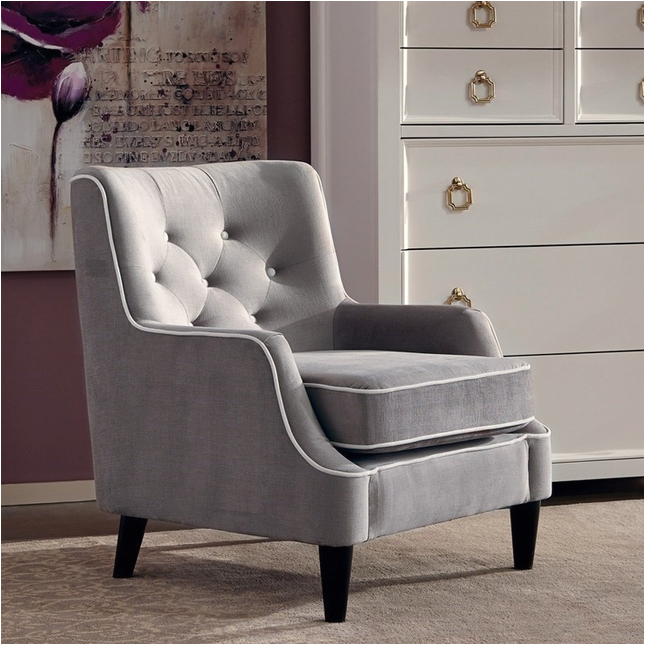 grey button tufted accent chair with white welted trim