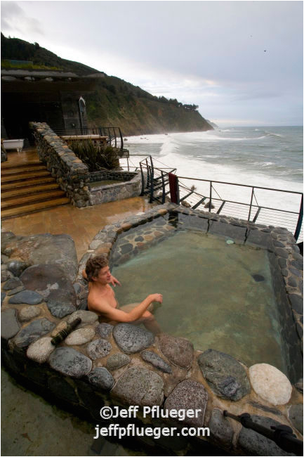 Man soaking bathing watching winter storm over ocean from Esalen hotsprings 1874