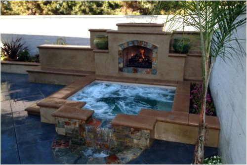 outdoor fireplace and hot tub