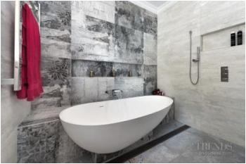 Semi Freestanding Bathtub Designer Tiles and A Semi Freestanding Tub are Features Of