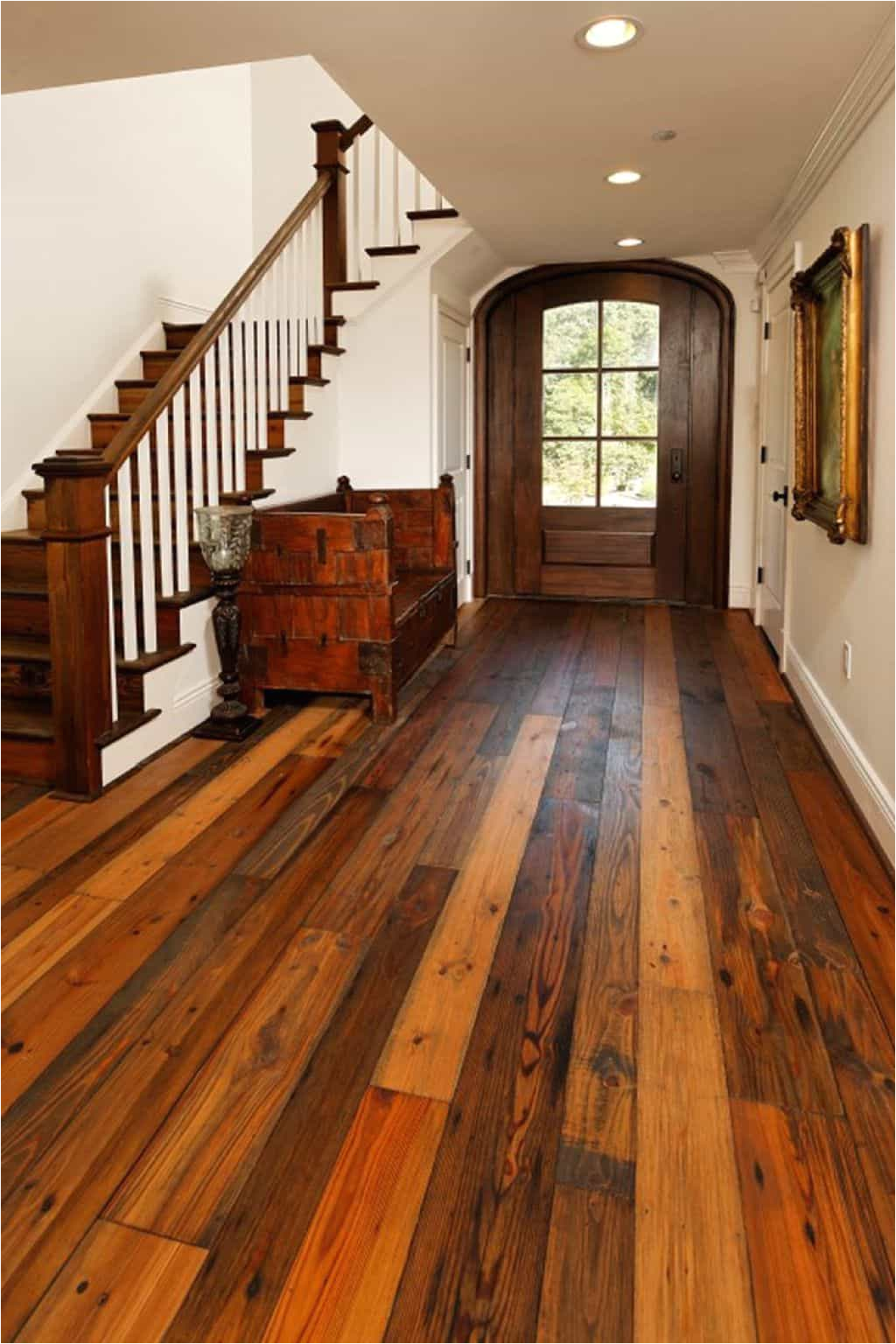 foyer designed with white walls and recycled wood flooring