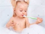 Baby Bath Tub for 2 Years Old Two Year Old Girl Taking A Bath and Brushing Teeth Stock