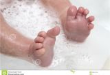 Baby Bath Tub with Legs Baby Feet Wet and soapy Royalty Free Stock Image