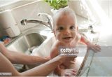 Baby Bathtub Kitchen Sink Baby Getting A Bath In Kitchen Sink From Mother Stock