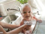 Baby Bathtub Kitchen Sink Baby Getting A Bath In Kitchen Sink From Mother Stock