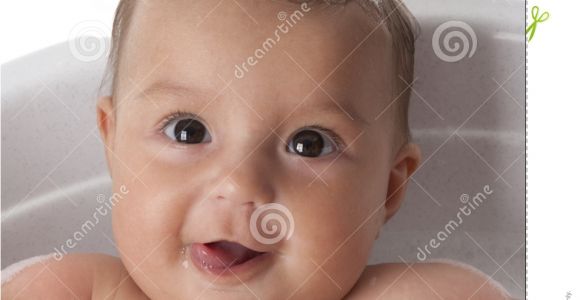 Baby Girl Bathtubs Baby Girl is Looking at Bubbles In Bathtub with F Stock